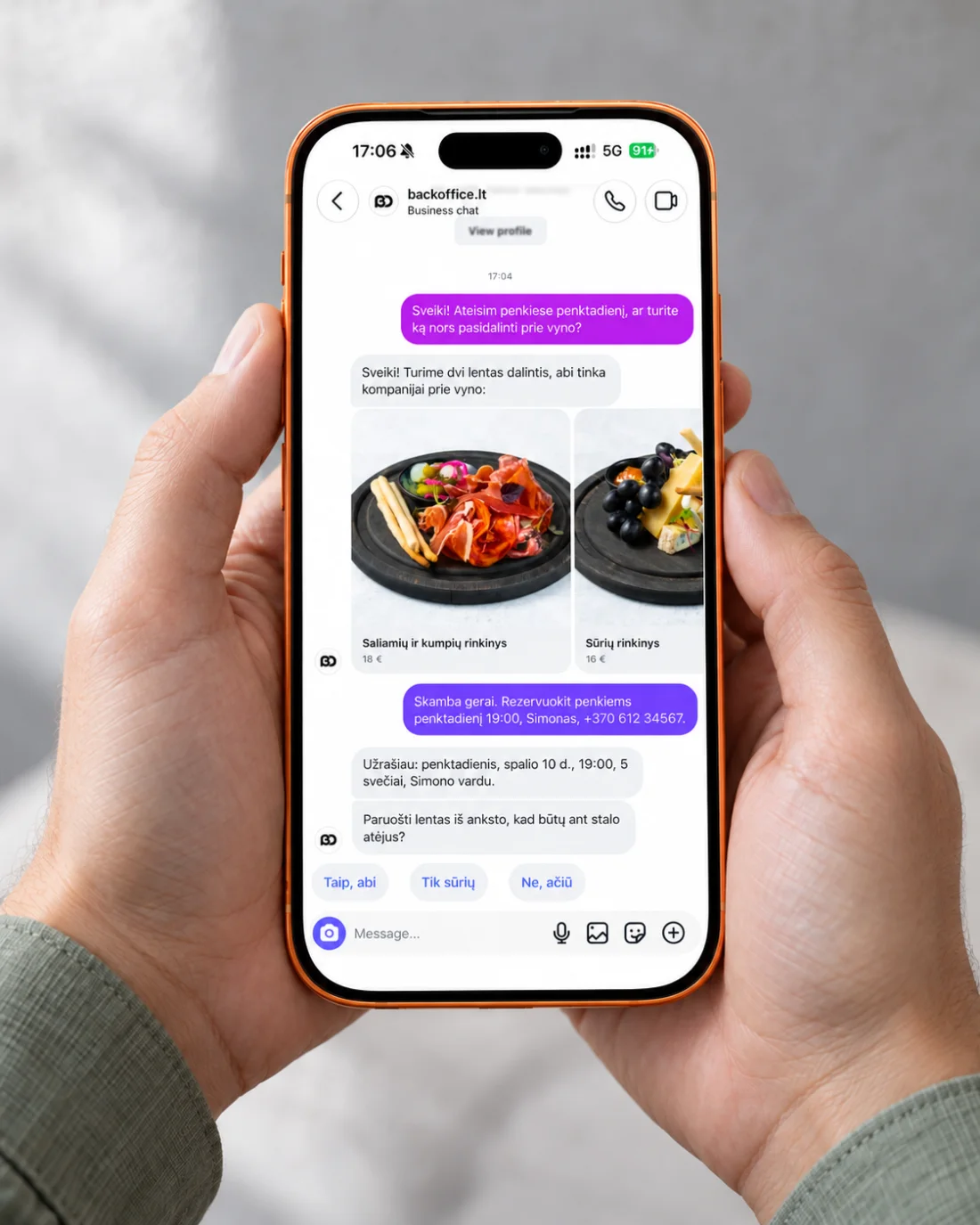 Two hands holding a phone with the same Instagram chat: the booking for five confirmed and a question about having the boards ready at the table